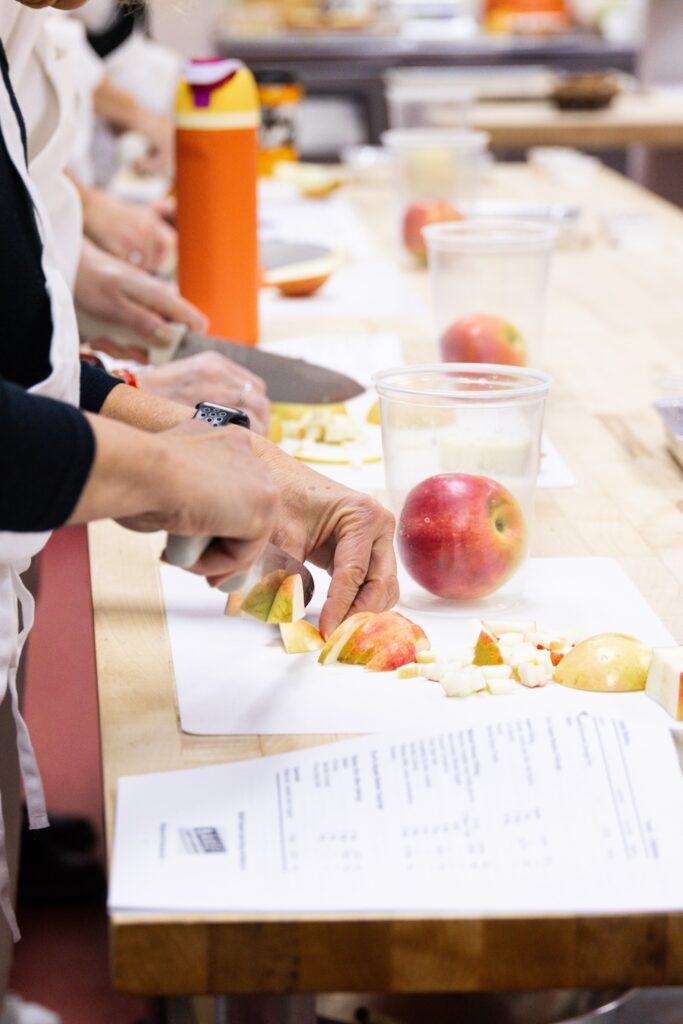 chopping apples in BAKE class